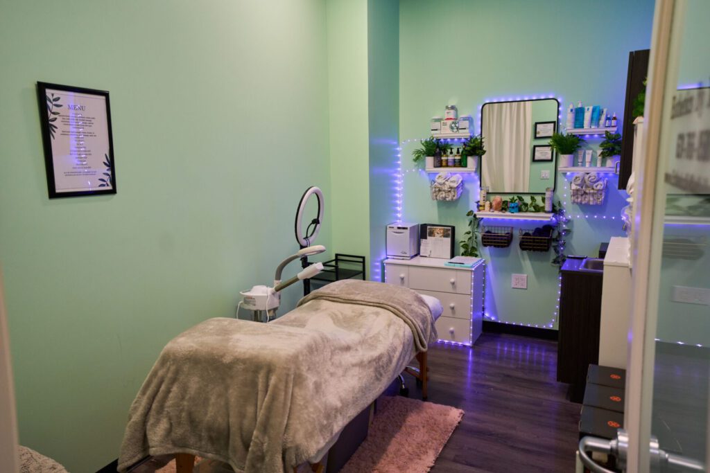 Cozy spa treatment room with green walls.