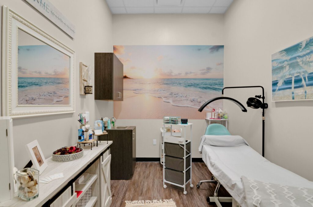 Cozy spa room with ocean-themed decor, treatment bed.