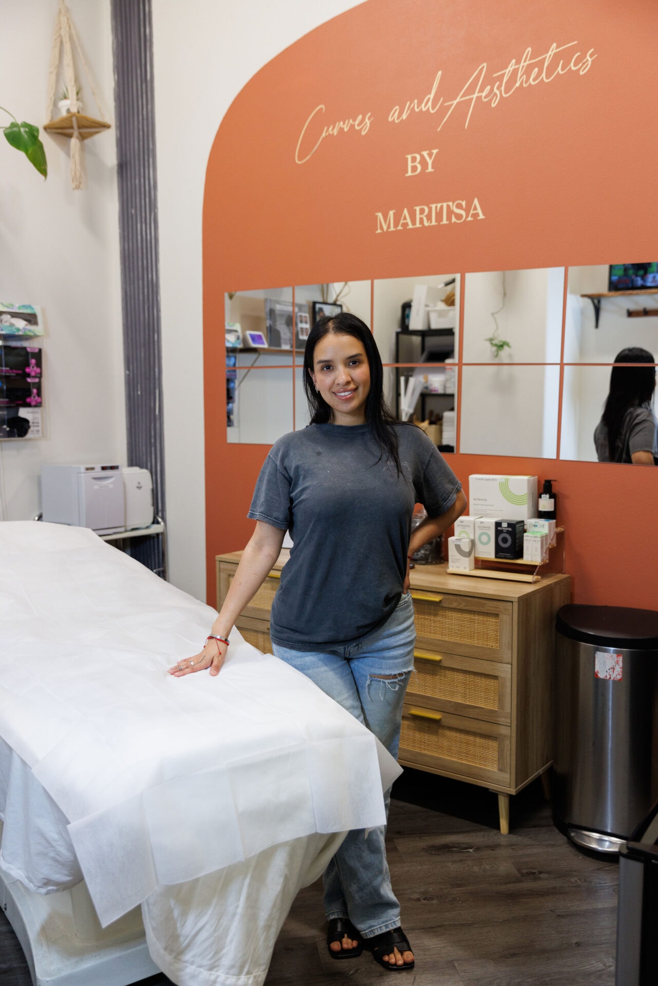 Woman standing in aesthetics treatment room.