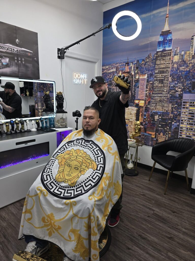 Barber styling client in modern barbershop with cityscape.