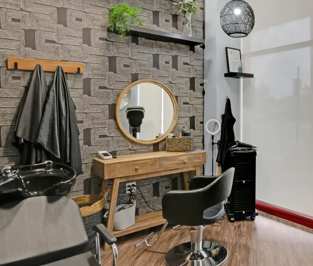 Modern hair salon interior with chair and mirror.
