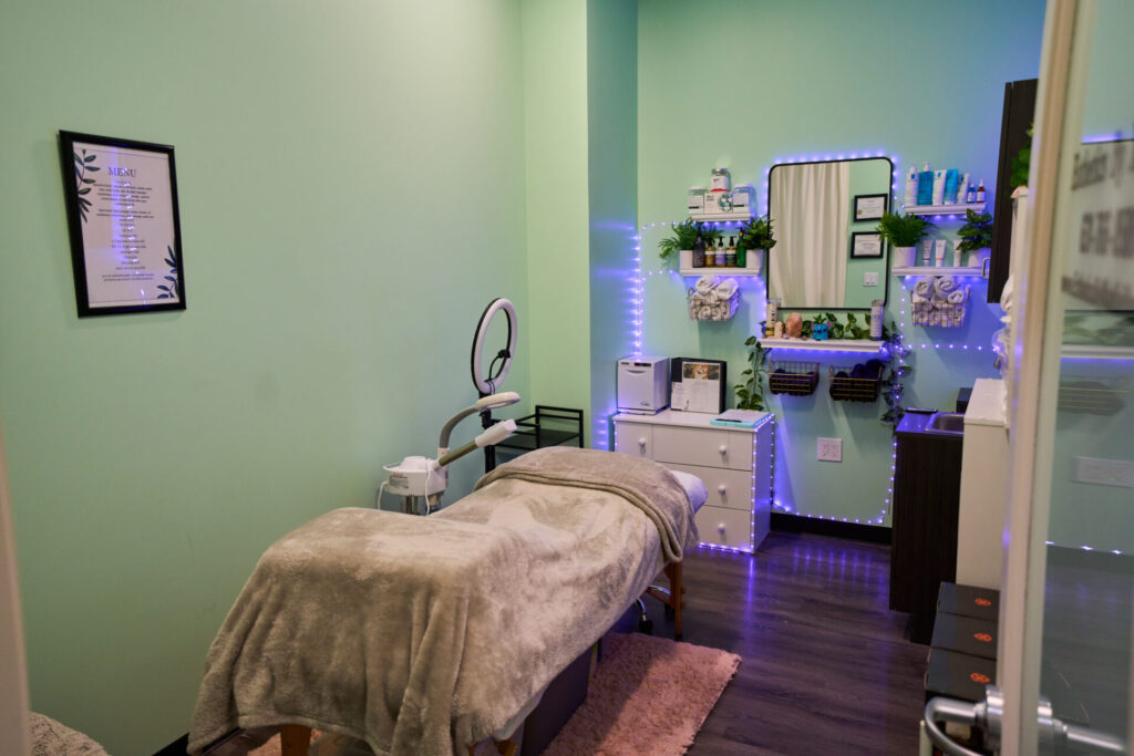 Serene spa room with massage bed and products.