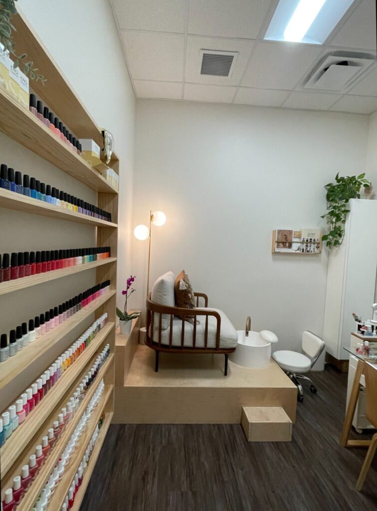Cozy nail salon with seating and polish display