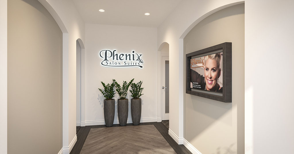 Phenix Salon Suites entrance with poster and plants.