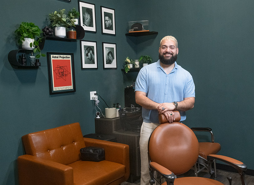 Barber smiling in modern styled shop.