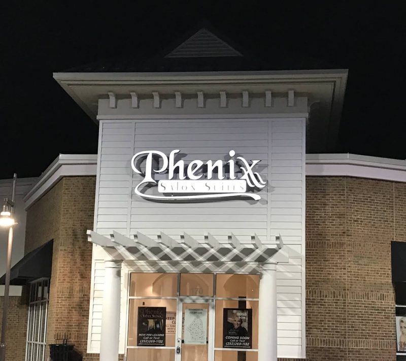 Phenix Salon Suites building exterior at night.