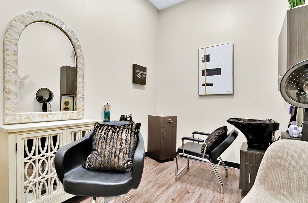 Modern hair salon with stylish decor and equipment.
