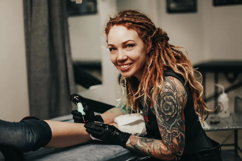 Smiling tattoo artist working in studio