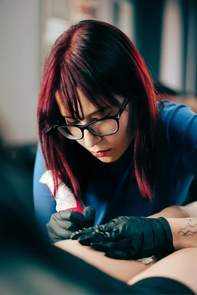 Tattoo artist concentrating during work session