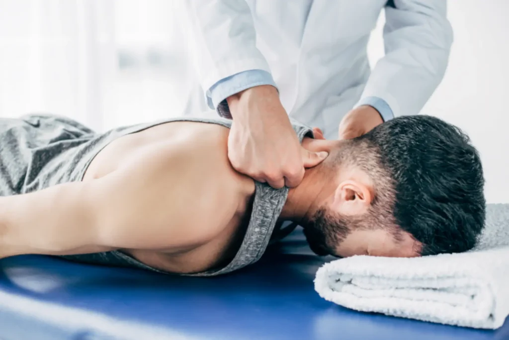 Chiropractor performing neck adjustment on patient.