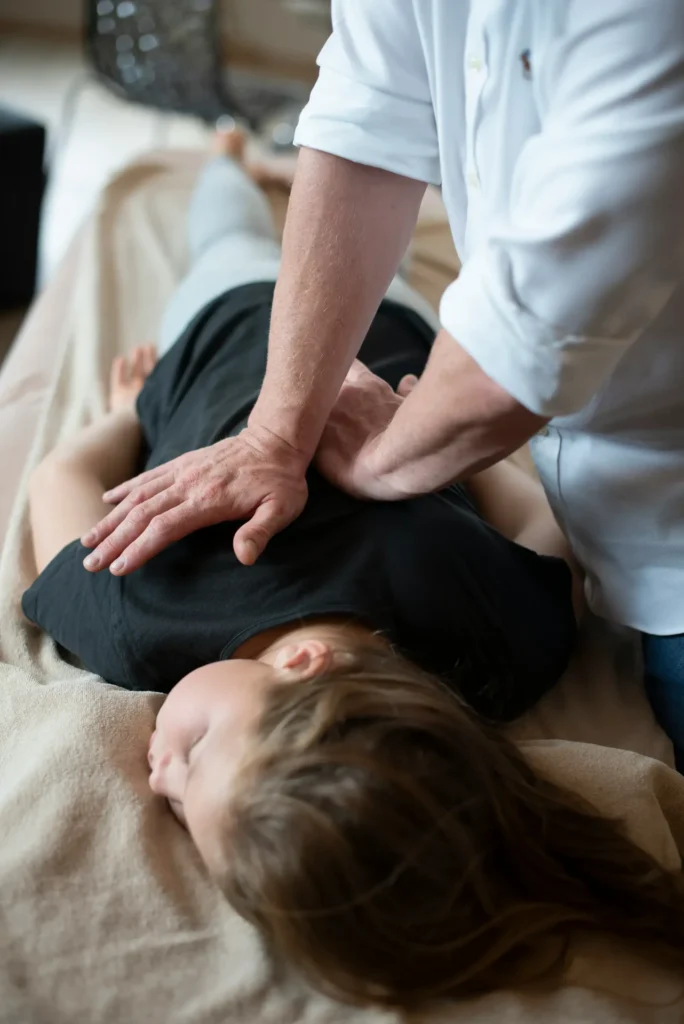 Chiropractor performing adjustment on patient's back