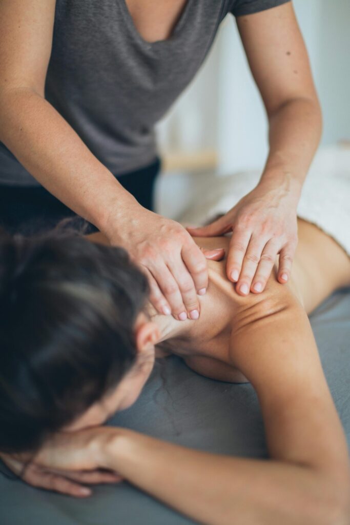 Person receiving massage therapy on back.