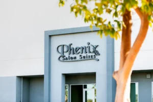 Phenix Salon Suites storefront exterior with tree