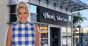Woman standing outside Phenix Salon Suites storefront
