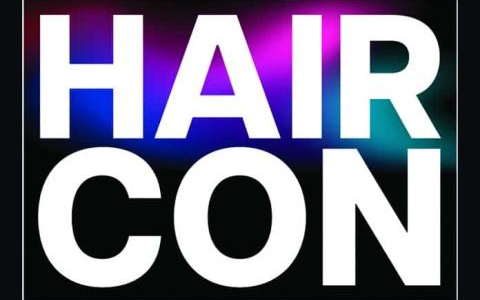 HAIR CON text on dark background